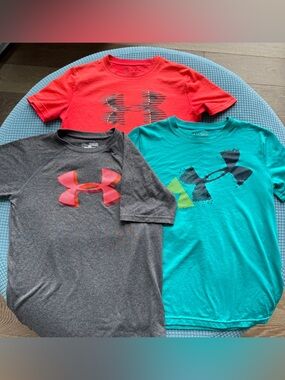 Under Armour youth medium loose fit / heat gear shirts.